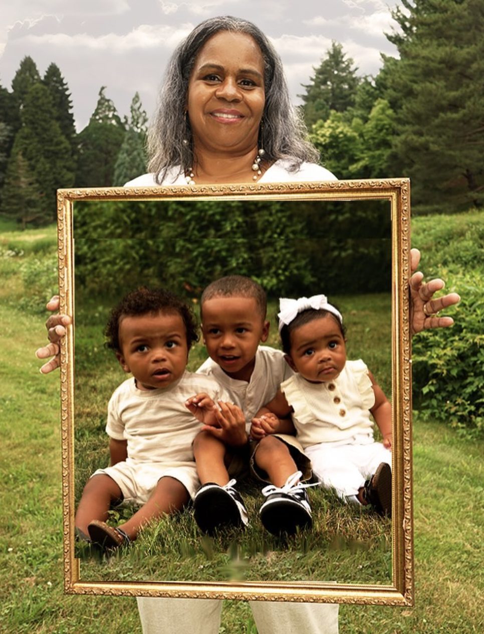A grandmother holding a gold frame around her three grandchildren.